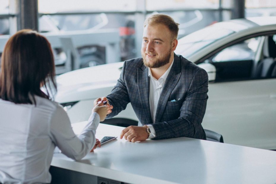 xman with sales woman car showroom.jpg.pagespeed.ic.OrLmFR9qrj
